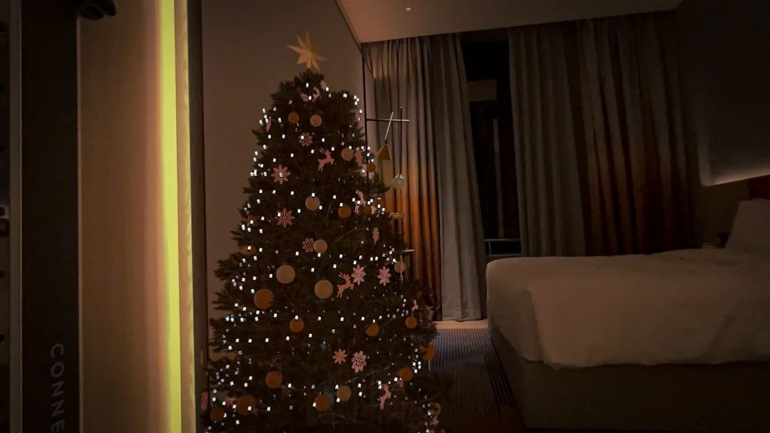 A decorated Tree Magic Christmas tree placed in a room with Apple Vision Pro